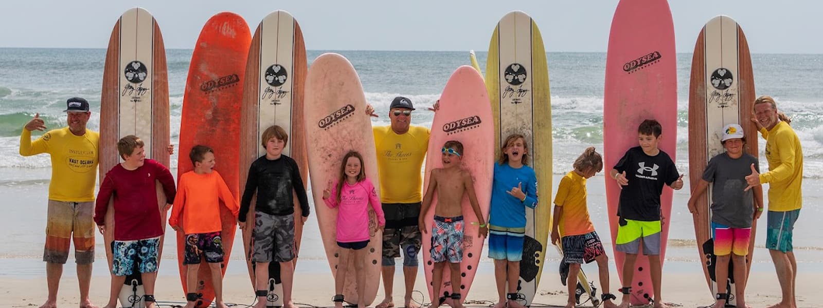 Surf students with longboards on the beach